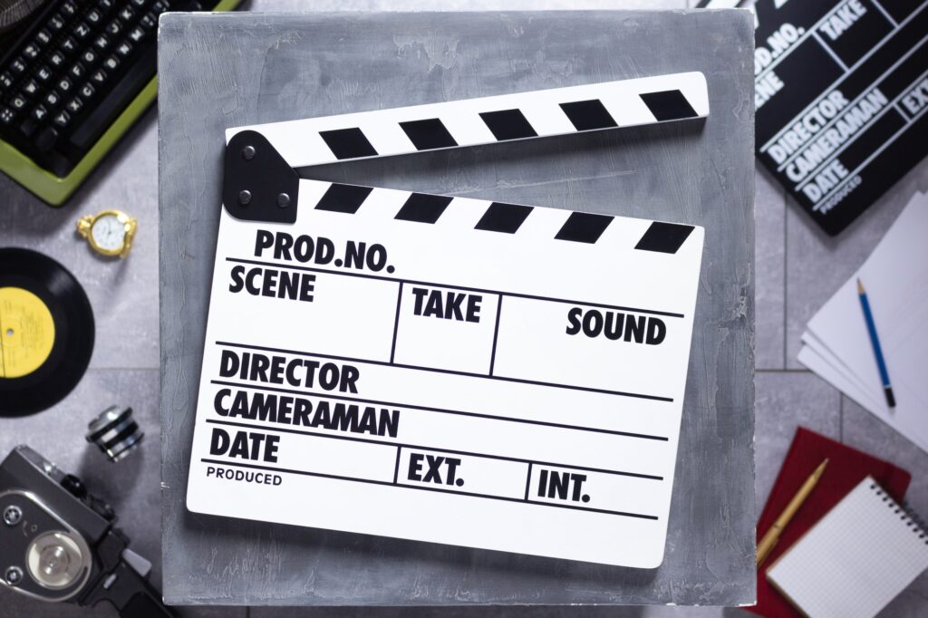 Movie clapboard or clapper at old table. Clapperboard and screenwriter or movie writer concept